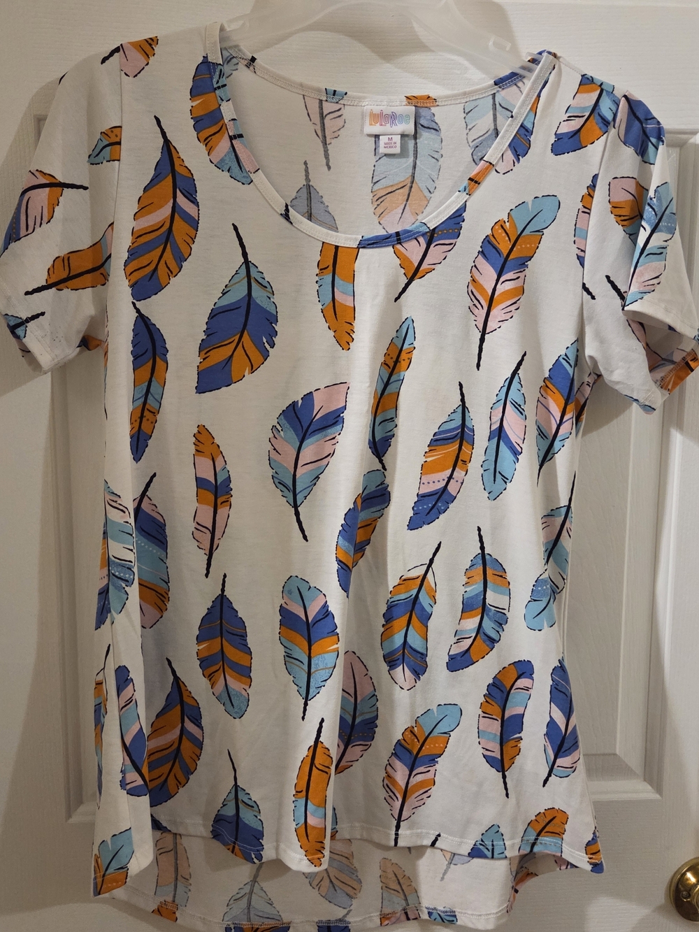 LuLaRoe White Short Sleeve Tee with Blue, Orange & Pink Feather Print